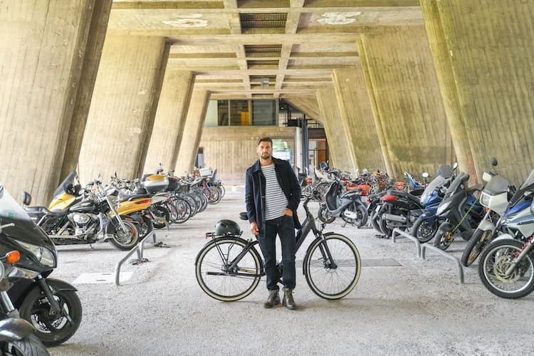 Man beside an electric bike in a motocycles parking